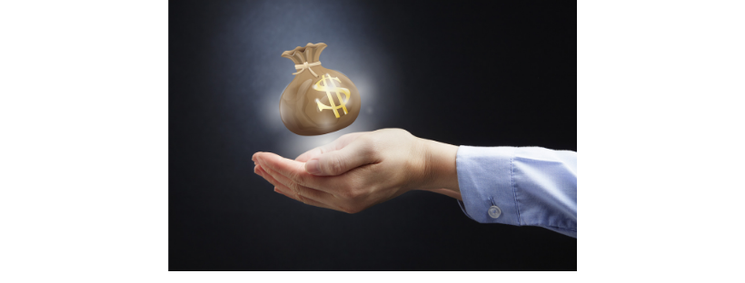 A person's hand, dressed in a light blue shirt sleeve, is extended palm up, holding a floating, glowing bag of money with a dollar sign on it, symbolizing Southern California Trust Administration against a dark background.